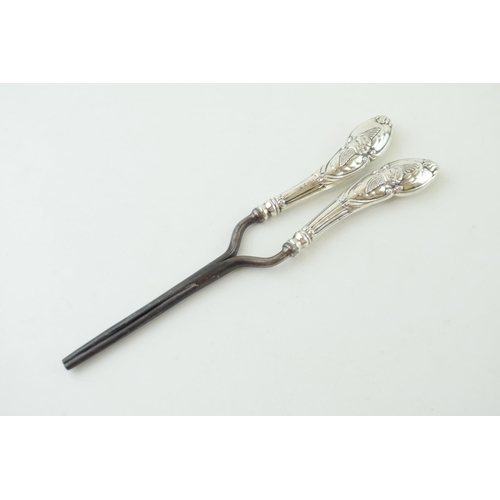 333 - Silver handled curling tongs with repousse work winged cherub design to handles. Hallmarked Birmingh... 