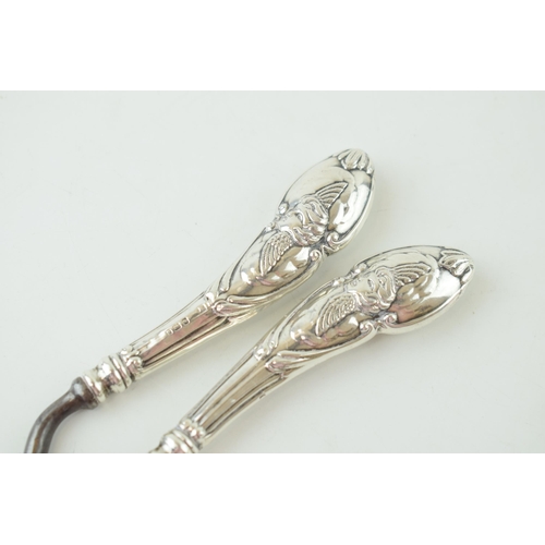 333 - Silver handled curling tongs with repousse work winged cherub design to handles. Hallmarked Birmingh... 