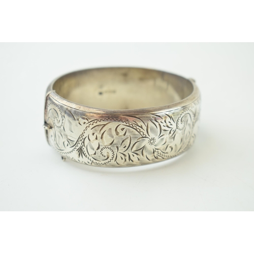 342 - Vintage silver bangle with hand chased repeated design. Weight 40 grams.