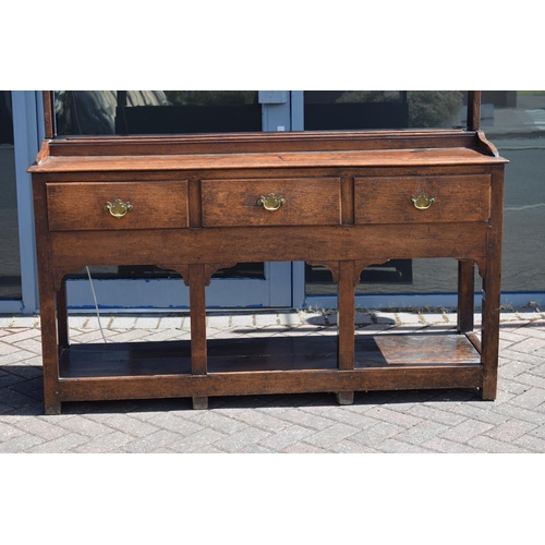 38 - Georgian oak dresser with three drawers to base, plank bottom, with oak plate rack, with later fitte... 