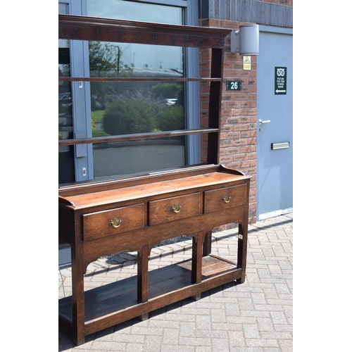 38 - Georgian oak dresser with three drawers to base, plank bottom, with oak plate rack, with later fitte... 