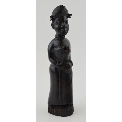 84 - African tribal figure of a lady with hands clasped over waste. Height 26cm.