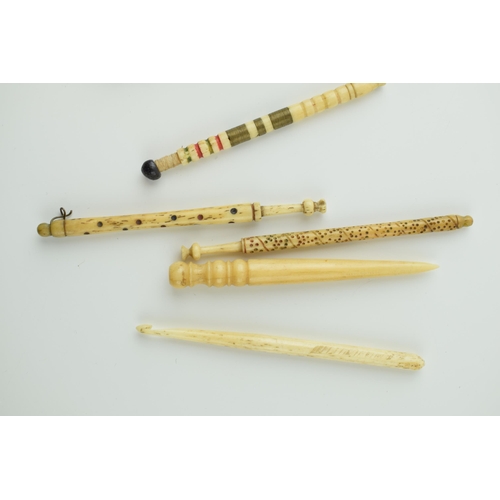 25 - A collection of bovine bone lacemaking bobbins, fids and lace makers tools, one with beads and one b... 