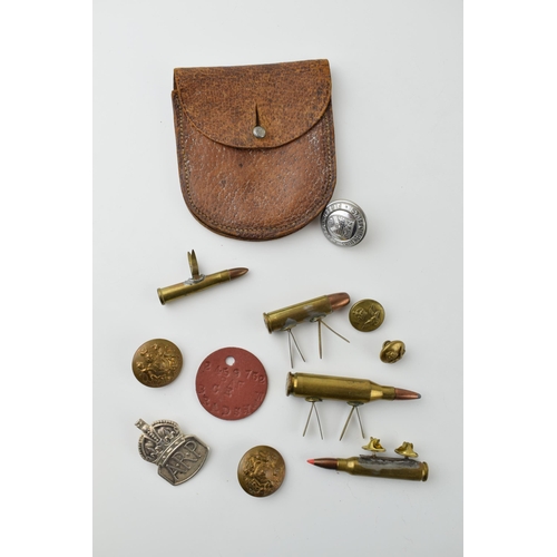 27 - A collection of military items to include A.R.P silver badge, Leather WWi pocket watch case and othe... 