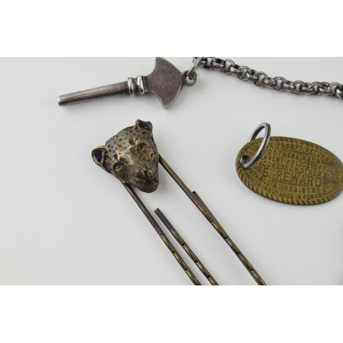 36 - A mixed lot to include antique Lepoard head paper clip, two gun metal keys on chains, two watch keys... 