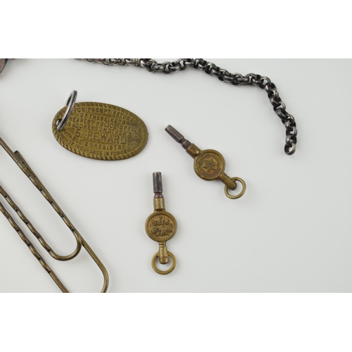 36 - A mixed lot to include antique Lepoard head paper clip, two gun metal keys on chains, two watch keys... 