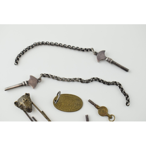 36 - A mixed lot to include antique Lepoard head paper clip, two gun metal keys on chains, two watch keys... 