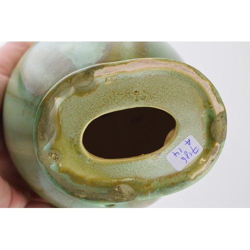 74 - An Art Deco pottery lamp base, stepped design with swirling body, mottled green, 25.5cm tall.