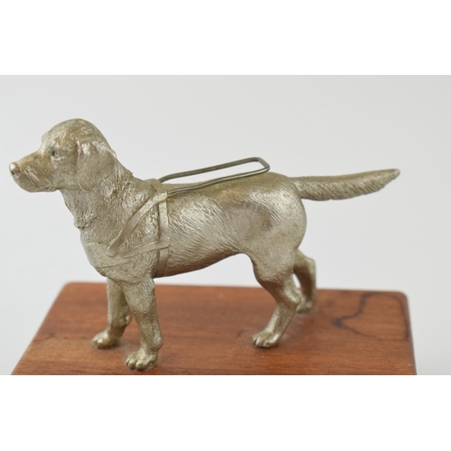 76 - A pewter model of a guide dog, mounted on wooden plinth, 12cm tall.