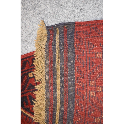 214 - A Middle Eastern runner rug in blue, reds and cream. Length 268cm x 65cm.