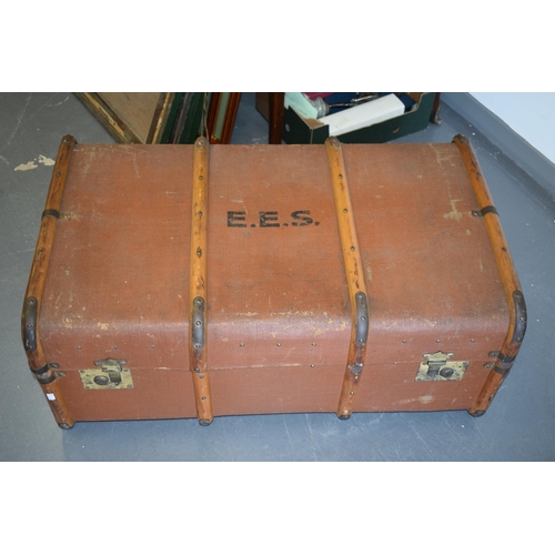 225 - A travel trunk with wooden banding and brass catches. Inner tray present and clean. Leather straps t... 