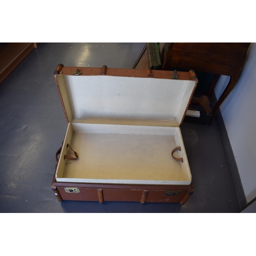 225 - A travel trunk with wooden banding and brass catches. Inner tray present and clean. Leather straps t... 