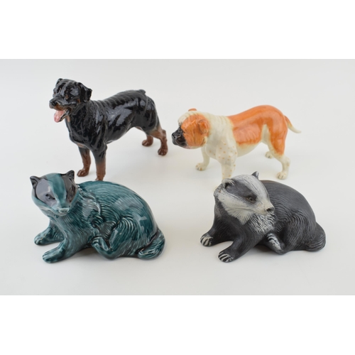 114 - Royal Doulton dogs to include a bulldog RDA 107 and one similar, with a pair of Poole badgers, one i... 