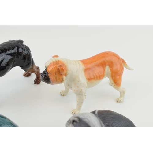 114 - Royal Doulton dogs to include a bulldog RDA 107 and one similar, with a pair of Poole badgers, one i... 