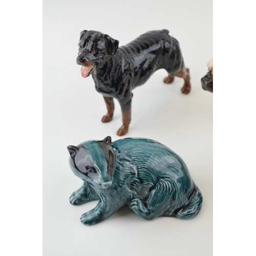 114 - Royal Doulton dogs to include a bulldog RDA 107 and one similar, with a pair of Poole badgers, one i... 