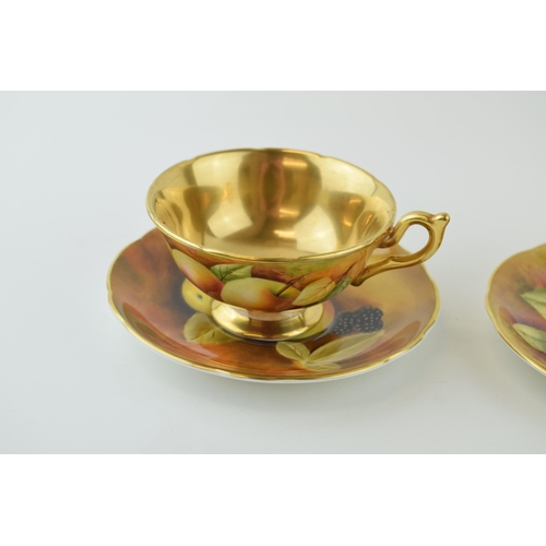 141 - Two hand-painted Coalport cabinet cups and saucers signed by J Mallram and C. Gidman. Heavy gilding.... 