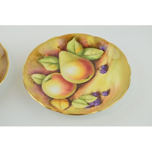 141 - Two hand-painted Coalport cabinet cups and saucers signed by J Mallram and C. Gidman. Heavy gilding.... 