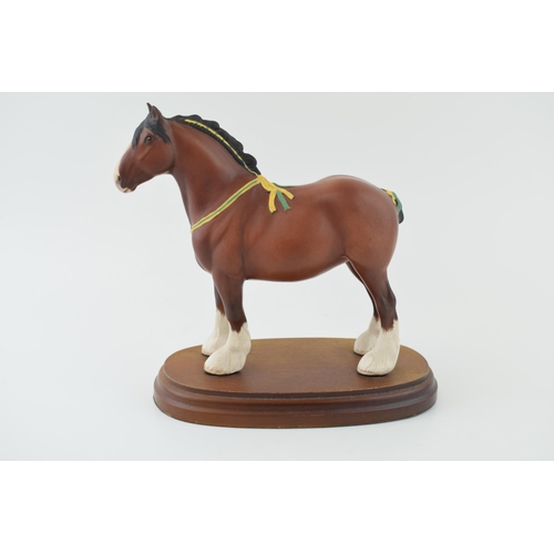 22 - Boxed Royal Doulton bay shire horse with yellow and green ribbon, on wooden base, 19cm wide.