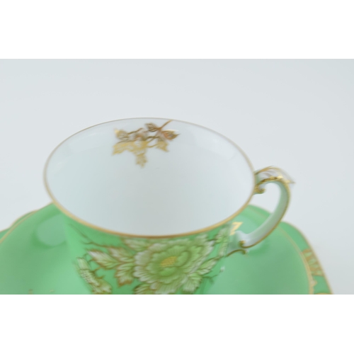 80 - Noritake trio decorated in a floral design with green background and gold highlights (3).