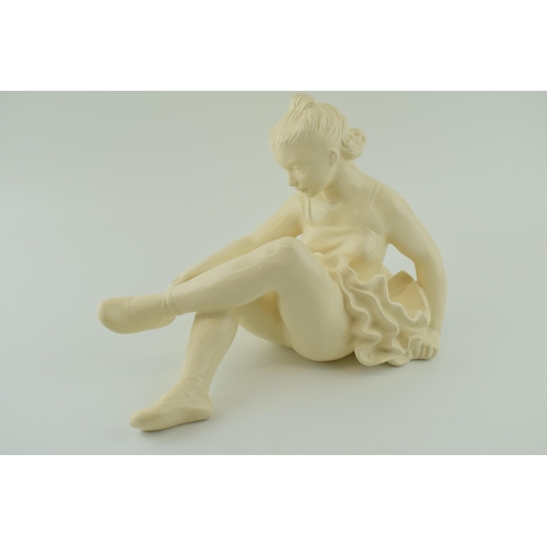 93 - Jihokera Bechyne, Czechoslovakia, mid century figure of a ballerina tightening her shoe, 31cm long.