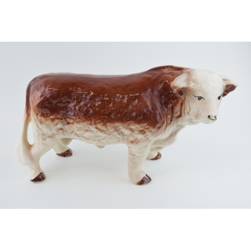 94 - A large mid 20th century butchers shop advertising figure of a Hereford Bull, with horns, 39cm long,... 