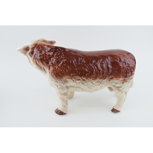 94 - A large mid 20th century butchers shop advertising figure of a Hereford Bull, with horns, 39cm long,... 