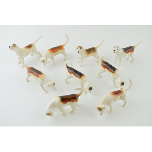 12 - A collection of Beswick foxhounds of varying shapes and models, two matt (9).