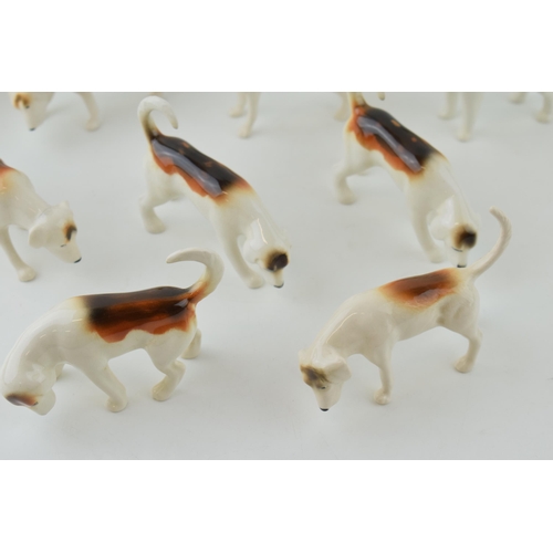 12 - A collection of Beswick foxhounds of varying shapes and models, two matt (9).