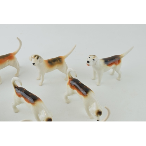 12 - A collection of Beswick foxhounds of varying shapes and models, two matt (9).