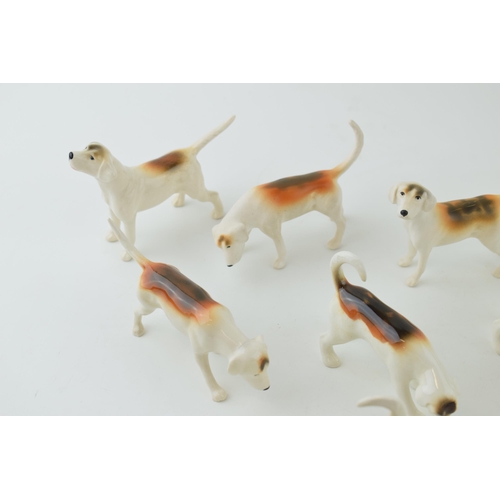 12 - A collection of Beswick foxhounds of varying shapes and models, two matt (9).