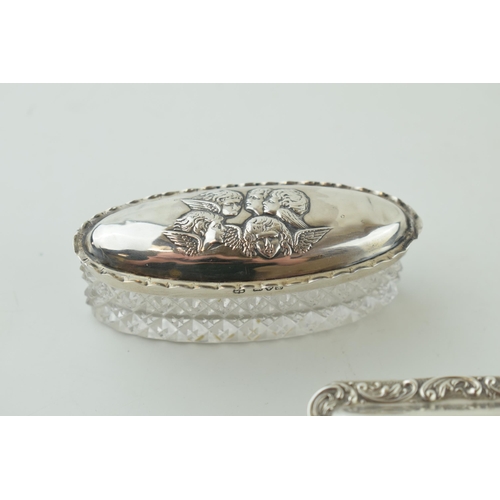 489 - A pair of silver topped glass pill / trinket boxes, one with Reynolds Angels, Chester 1904 and Birmi... 