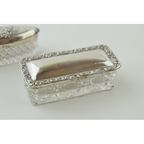 489 - A pair of silver topped glass pill / trinket boxes, one with Reynolds Angels, Chester 1904 and Birmi... 