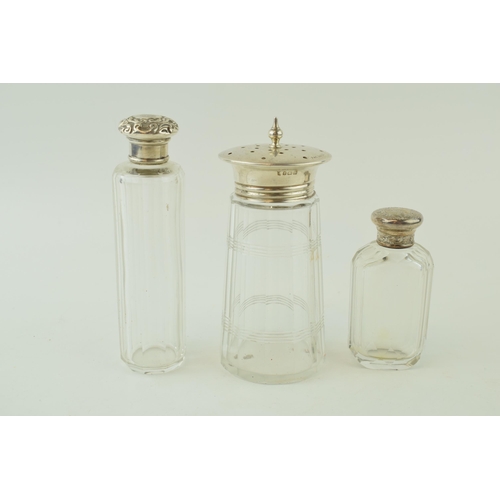 495 - A pair of silver topped glass jars to include a sugar sifter and one other, the smallest being plate... 