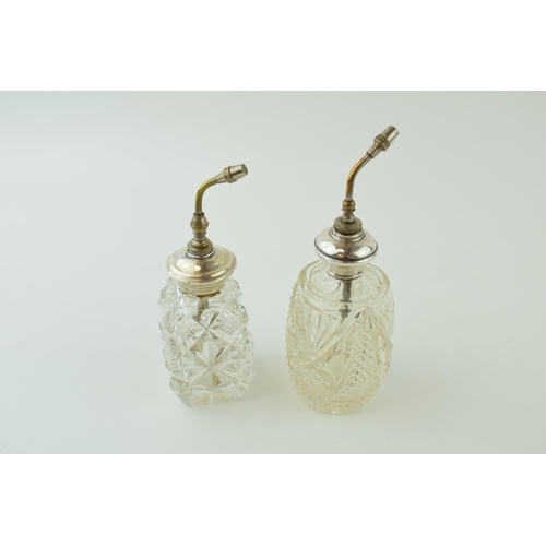 499 - A near pair of silver collared spray scent bottles, stamped sterling, 16cm tall (2).