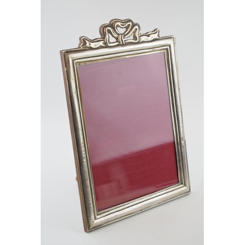 500 - Silver (800) fronted photo frame with bow and ribbon decoration, easel back, 33cm tall.