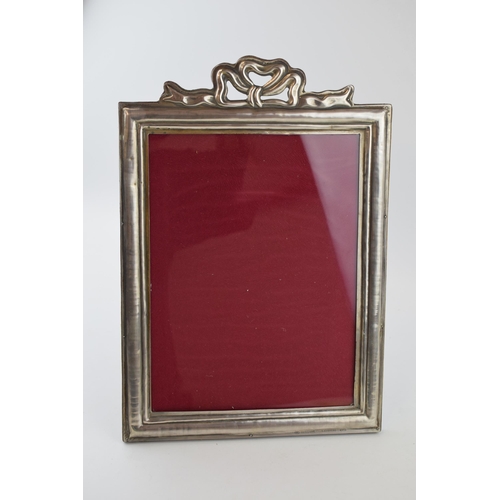 500 - Silver (800) fronted photo frame with bow and ribbon decoration, easel back, 33cm tall.