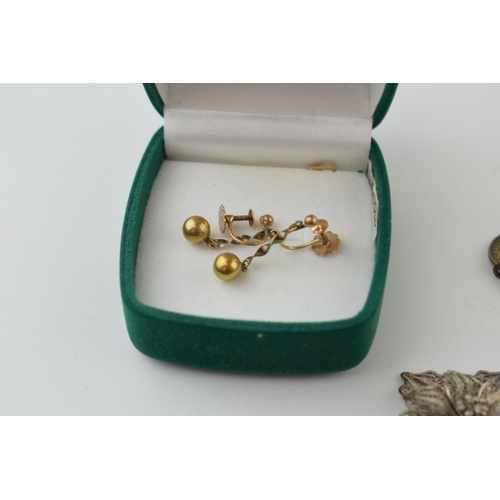 511 - A pair of 9ct yellow gold earrings (1.6 grams) together with pre 1947 silver coins on a bracelet, a ... 