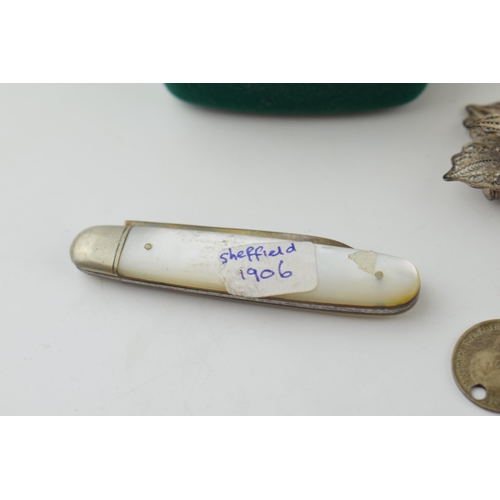 511 - A pair of 9ct yellow gold earrings (1.6 grams) together with pre 1947 silver coins on a bracelet, a ... 