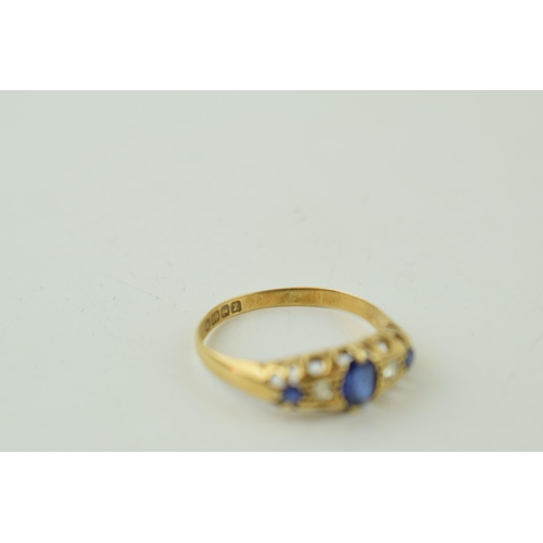 515 - 18ct yellow gold ring set with Diamonds and Sapphires. Large central Sapphire with two Diamonds eith... 