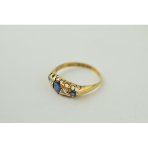 515 - 18ct yellow gold ring set with Diamonds and Sapphires. Large central Sapphire with two Diamonds eith... 