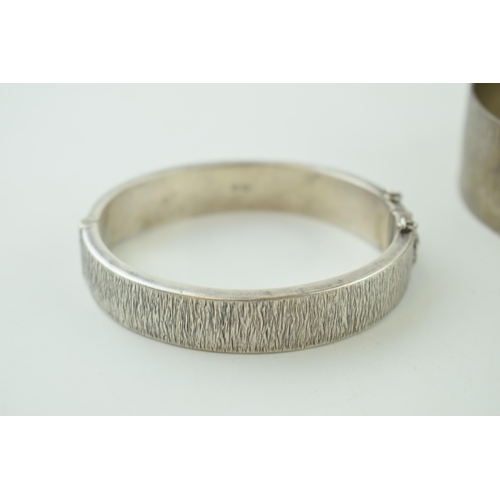 519 - A silver bark effect bangle with a similar bracelet, 69.5g, both hallmarked (2).