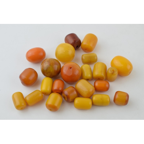 526 - A collection of loose butterscotch amber (or similar) beads, all drilled, circa 186g, varying sizes.