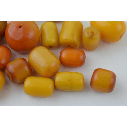 526 - A collection of loose butterscotch amber (or similar) beads, all drilled, circa 186g, varying sizes.