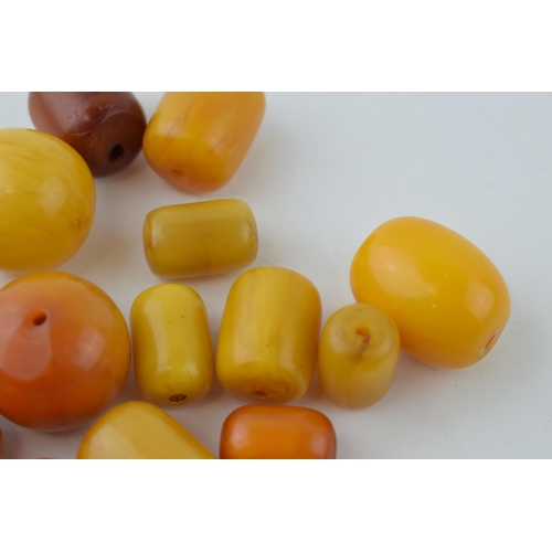 526 - A collection of loose butterscotch amber (or similar) beads, all drilled, circa 186g, varying sizes.