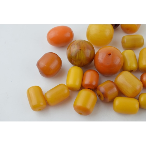 526 - A collection of loose butterscotch amber (or similar) beads, all drilled, circa 186g, varying sizes.