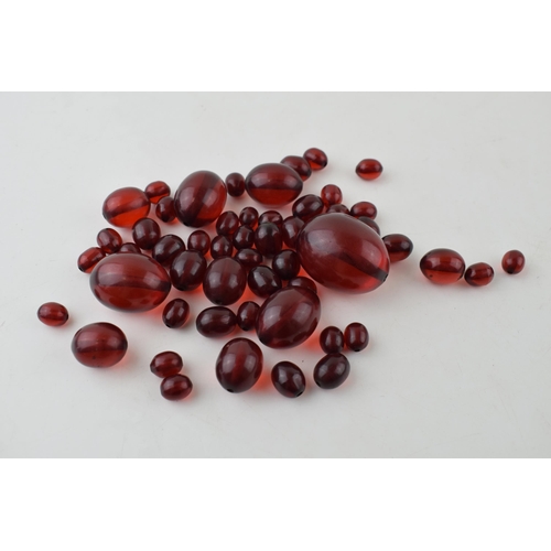 527 - A collection of cherry amber (or similar) to include graduated beads of varying sizes, 64.8g.