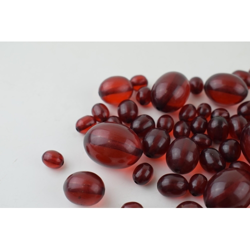 527 - A collection of cherry amber (or similar) to include graduated beads of varying sizes, 64.8g.