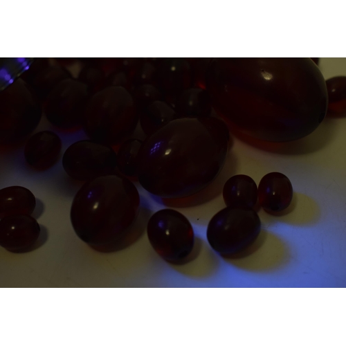 527 - A collection of cherry amber (or similar) to include graduated beads of varying sizes, 64.8g.