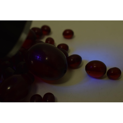 527 - A collection of cherry amber (or similar) to include graduated beads of varying sizes, 64.8g.