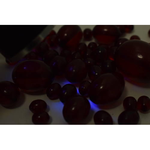 527 - A collection of cherry amber (or similar) to include graduated beads of varying sizes, 64.8g.